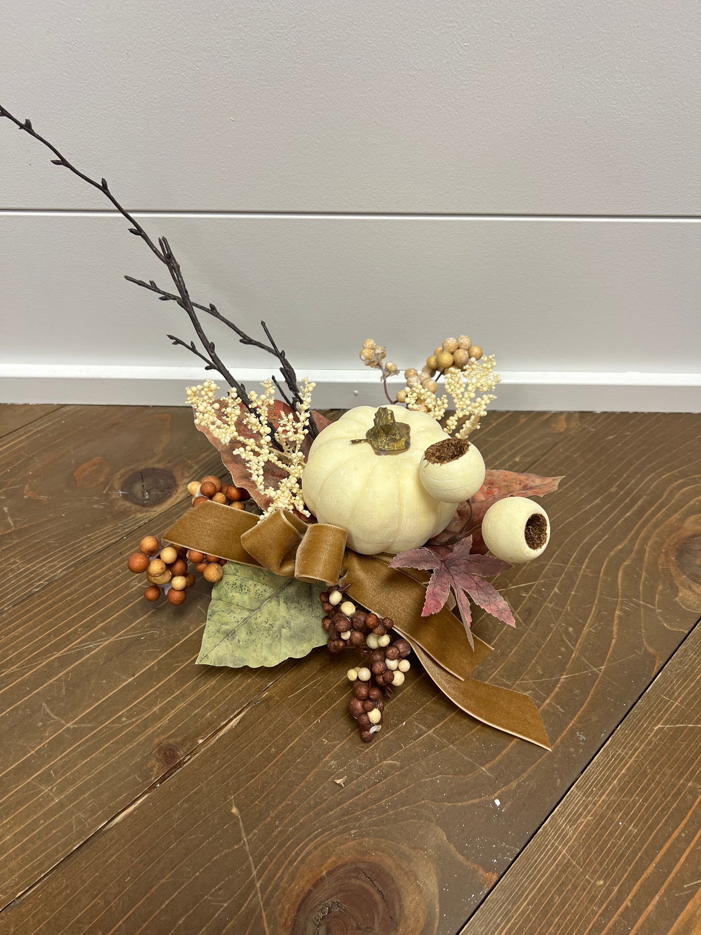 Pumpkin in brown container with suede ribbon